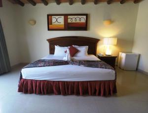 Hotel El Campanario Playa del Carmen tesisinde bir odada yatak veya yataklar