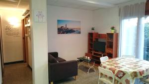a living room with a table and a couch at Apartamentos Juan Jose in Lloret de Mar