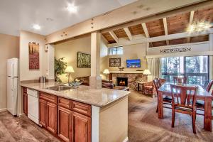 a kitchen and dining room with a table and a fireplace at Lake Tahoe's Premier Beach, Mountain & Ski Getaway in South Lake Tahoe