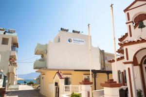 a building with a sign on the side of it at Kissamia Rooms - Next to Night Clubs in Kissamos