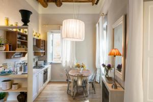 a kitchen with a table and a dining room at Stence Apartment in Lucca