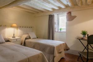 a bedroom with two beds and a window at Stence Apartment in Lucca