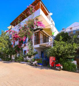 a building with flowers on the side of it at Ates Pension in Kas