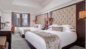 a hotel room with two beds and two lamps at WestHouse Hotel New York in New York