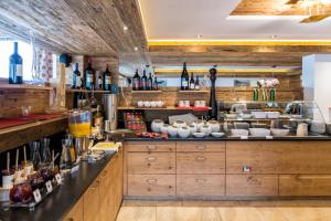 a kitchen with a counter with wine bottles at Passo Sella Dolomiti Mountain Resort in Selva di Val Gardena