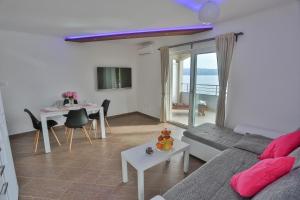 a living room with a couch and a table at Villa Poletto in Omiš