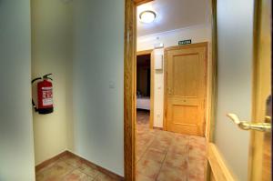 a hallway with a fire hydrant and a door at El Val in Arguedas