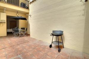 a grill sitting on a tiled floor next to a wall at El Val in Arguedas