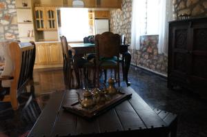 a living room with a table and chairs and a dining room at Ktima Lazarata in Lazaráta