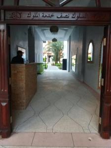 a man sitting at a counter in a building at Manis Apartment Set in a Hotel Area in Marrakesh