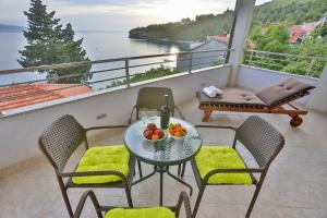 a table with a bowl of fruit on a balcony at Villa Poletto in Omiš