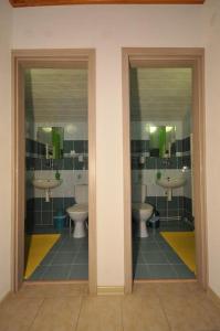 a bathroom with two sinks and two toilets at Penzión pod Troma Korunami in Červený Kláštor +46 photos
