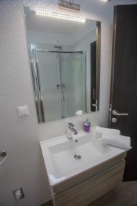 a bathroom with a sink and a large mirror at Villa Poletto in Omiš +27 photos