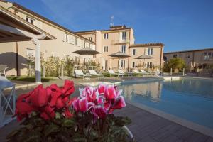 a villa with a swimming pool and pink flowers at Il Tremarino in Camaiore