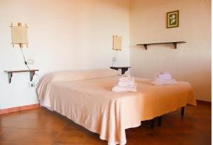 a room with a bed with towels on a table at Fighezia in Fluminimaggiore