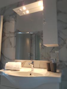 a bathroom with a sink and a mirror at Apartments Nika in Trogir