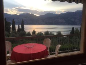 a table and chairs on a balcony with a view of a lake at Casa Angelo in Malcesine