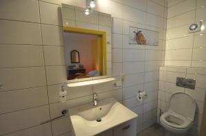 a bathroom with a sink and a toilet at B&B Le Verger du Pierroy in Louftémont