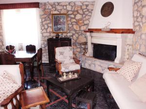 a living room with a couch and a fireplace at Ktima Lazarata in Lazaráta