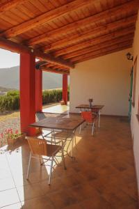 a patio with tables and chairs and a view at Fighezia in Fluminimaggiore