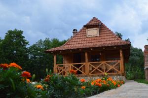 a small wooden building with a roof at Apartment Mateja in Mokra Gora