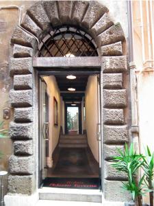 an entrance to a building with a hallway with stairs at Relais Palazzo Taverna in Rome