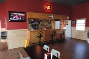 a restaurant with a bar with a tv on the wall at North 99 Motel in Twillingate