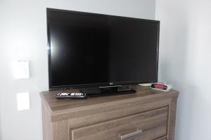 a flat screen tv sitting on top of a dresser at North 99 Motel in Twillingate