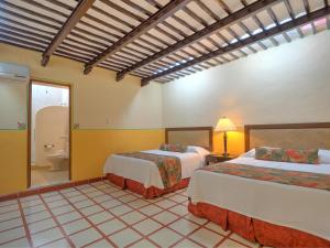 Tempat tidur dalam kamar di Hotel Luz en Yucatan