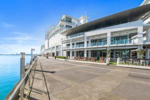 a large building next to a body of water at Princes Wharf - Absolute Waterfront & Great Views in Auckland