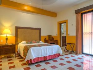 A bed or beds in a room at Hotel Luz en Yucatan