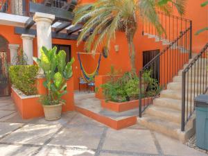 un bâtiment orange avec des escaliers et des plantes devant lui dans l'établissement Hotel Luz en Yucatan, à Mérida