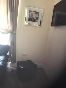 a room with a window and a black stool at River Ness Apartments in Inverness