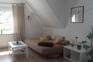 um pequeno quarto com uma cama e uma mesa em Ferienwohnung-Kuechler em Oelsnitz