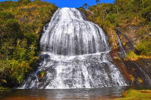 a waterfall on the side of a hill with water at Hospedagem Alternativa Família Martins in Urubici