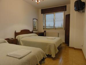 Postel nebo postele na pokoji v ubytování Pensión Monterredondo