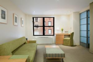 a living room with a couch and a window at Shoreham Hotel in New York