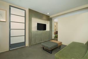 a room with a bed and a tv on a wall at Shoreham Hotel in New York