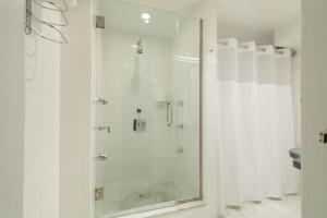 a shower with a glass door in a bathroom at Shoreham Hotel in New York