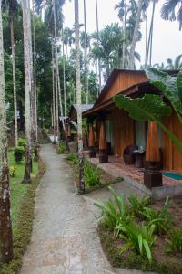 a path in front of a resort with palm trees at TSG Blue Resort & Spa in Havelock Island