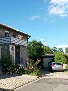 a house with a car parked in front of it at Ferienwohnung Christa in Bad Staffelstein