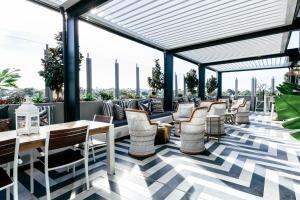 a restaurant with chairs and tables on a roof at Nautica Residences Fremantle in Fremantle