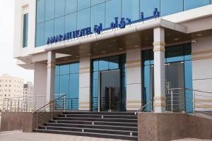 a building with a sign on top of it at Amarah Hotel in Muscat