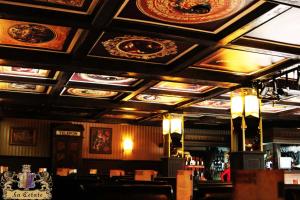 a bar with a ceiling with paintings on it at LaCetate Boutique Hotel in Piteşti