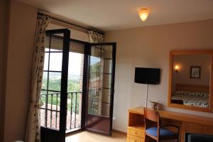 a room with a door open to a balcony at Casa Martín in Poza de la Sal