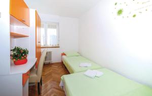 a small room with two beds and a desk at Apartment Skyscraper Maro in Rijeka