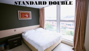 Postel nebo postele na pokoji v ubytování One Avenue Hotel