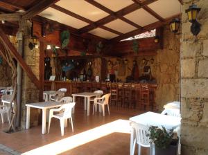 a restaurant with tables and chairs and a bar at Roman Boutique Hotel in Paphos