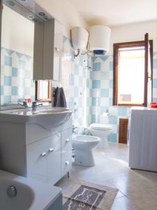 a bathroom with a sink and a toilet at Casa Vacanza Valledoria in Valledoria