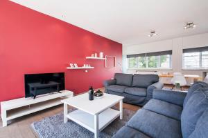 a living room with a red accent wall at K5 in Athens